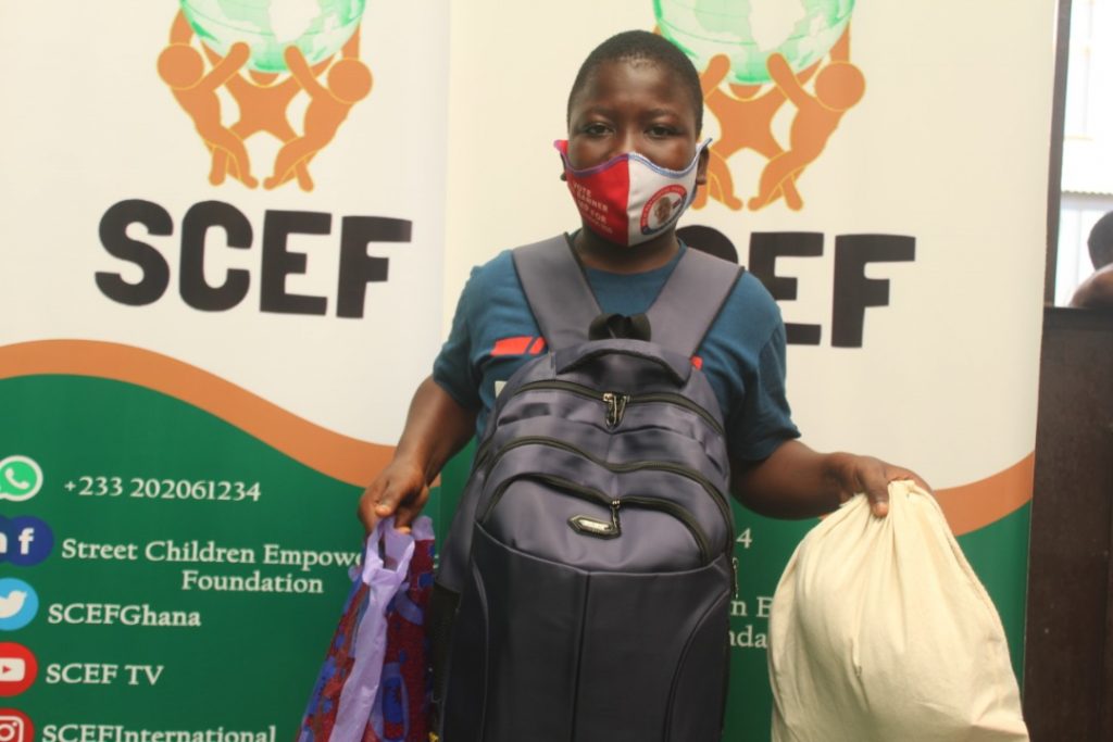 Solomon, a beneficiary of SCEF's Take Me Back to School for street children displays his school supplies